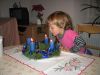 Martinka sfoukává svíčky na adventním věnci :-)